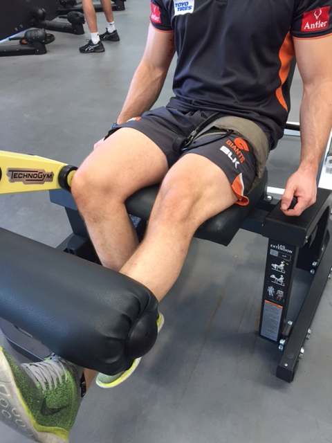 Cuff placed around the upper thigh during leg-extension training for quadriceps rehab prevents friction but can often become inflamed